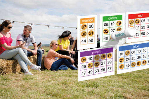 On the left a group of people sitting on the grass and haystacks enjoying tombola bingo games. On the right there is a floating different colour bingo cards with some numbers already coloured.